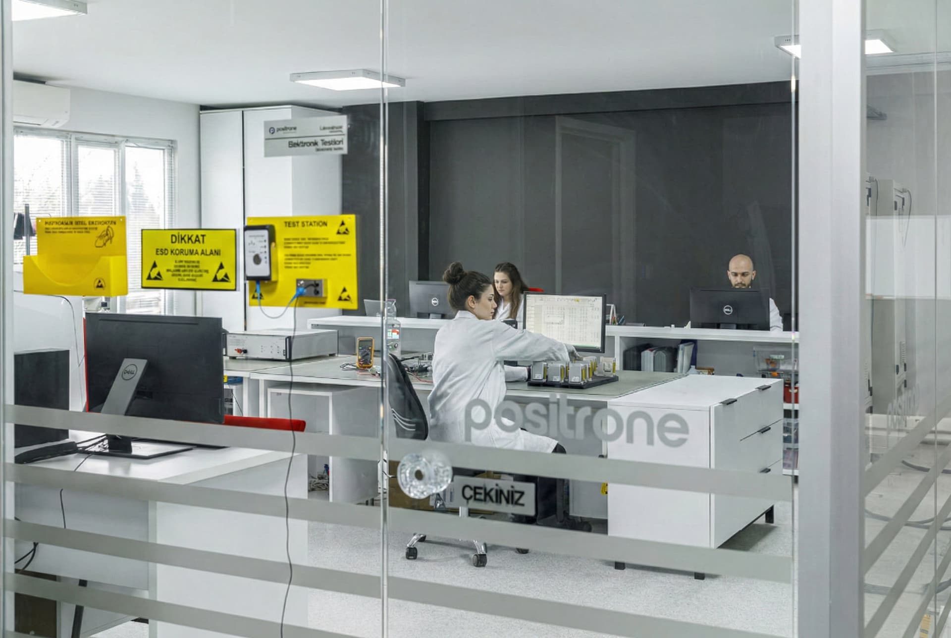 Positrone office and reception area with glass logo